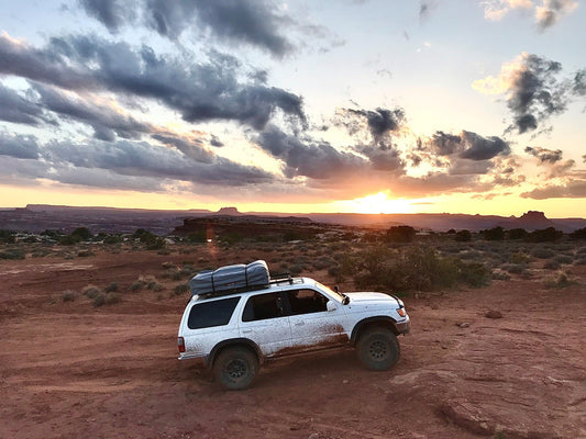 Off-Road 4Runner rock crawling with rooftop tent.